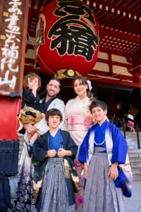 French Freestyle Footballer Séan Garnier & Influencer Souhila Garnier by JG Brasseur Garnier Family dressed in traditional Japanese kimono and hakama posing in front of a red temple gate with a large paper lantern in Tokyo, Japan.