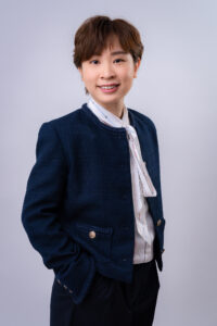 Professional Headshot of a Doctor in JG Studio in Tokyo Portrait of a professional woman in a navy blue blazer and scarf, smiling for a studio headshot in Tokyo, Japan.