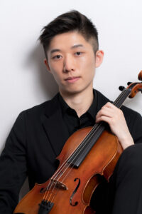 Professional Hong Kong Musician Man in a black suit holding a violin, posing against a white background.