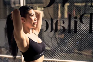 Pilates Instructor Portrait by JG Brasseur in Shibuya Professional portrait of a pilates instructor in Shibuya, Tokyo, captured by photographer JG Brasseur. The image features a woman stretching in natural light, highlighting fitness, wellness, and a modern studio environment.