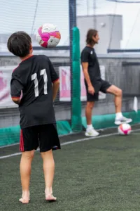 Young football players practice heading and ball control during a training session at Jeunesse Shonan elite football school in Japan.