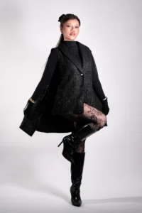 High Fashion Portrait in Black Ensemble Professional high fashion portrait of a model in a black vest, turtleneck, and fishnet stockings, posing in a Tokyo photo studio by JG Brasseur.