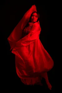 Colorful Portrait of a Japanese Dancer Editorial portrait of a person draped in flowing red fabric, dramatic lighting, professional photography by JG Brasseur.