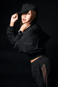 Streetwear Test Shoot – Alo Style Professional studio portrait of a woman in Tokyo wearing a black Alo Yoga streetwear ensemble, including a mesh cap and windbreaker, captured by JG Brasseur.